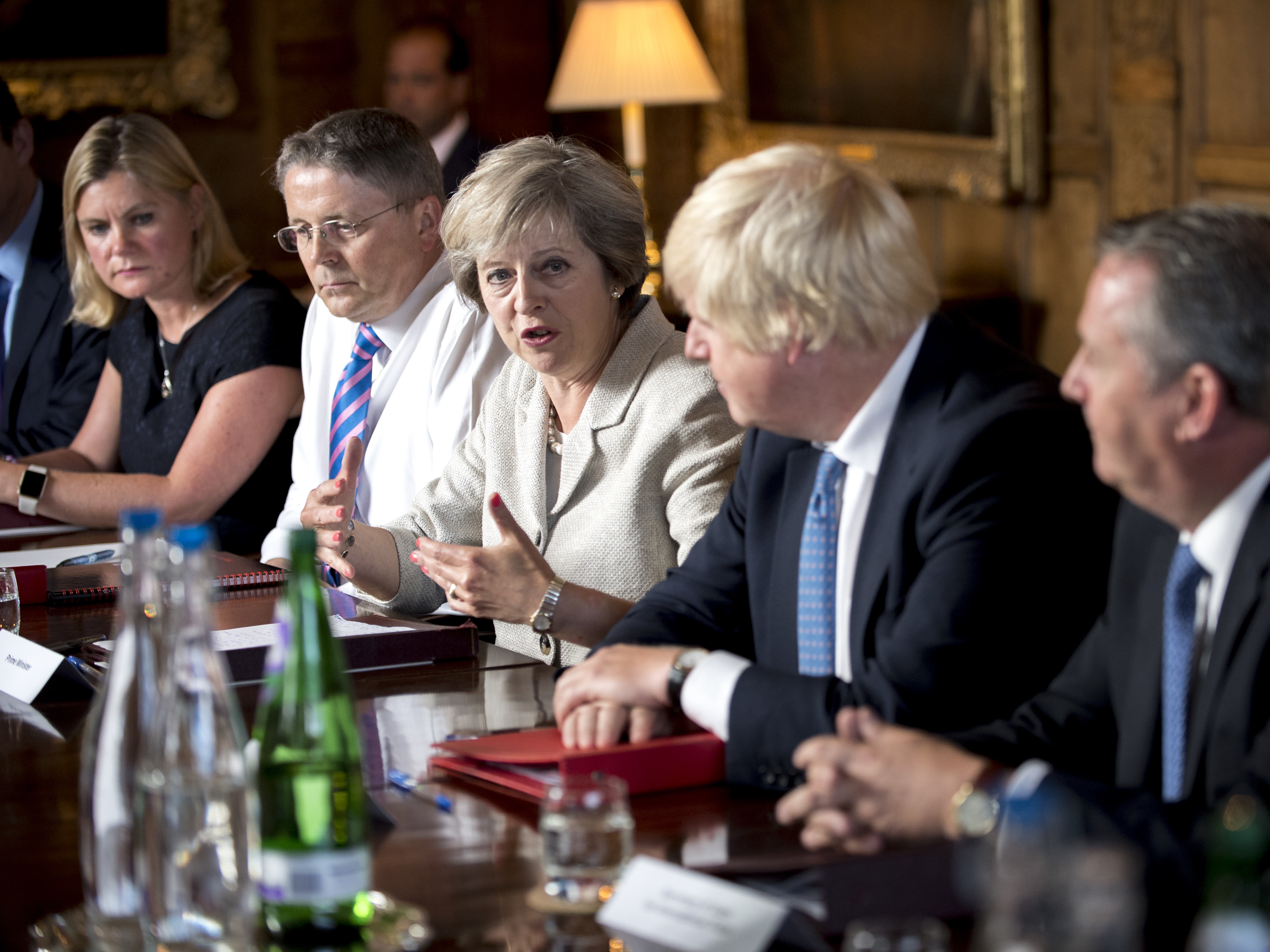 Theresa May, Prime Minister of the UK, and her new cabinet–including Boris Johnson, the former Mayor of London, (to her left)–will be in charge of negotiating Brexit with the European Union